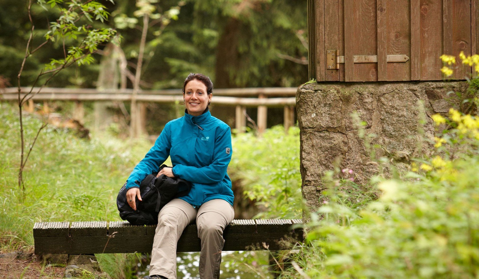 Ung kvinde sidder ved harvehuset, © Harzer Tourismusverband/ Marcus Gloger